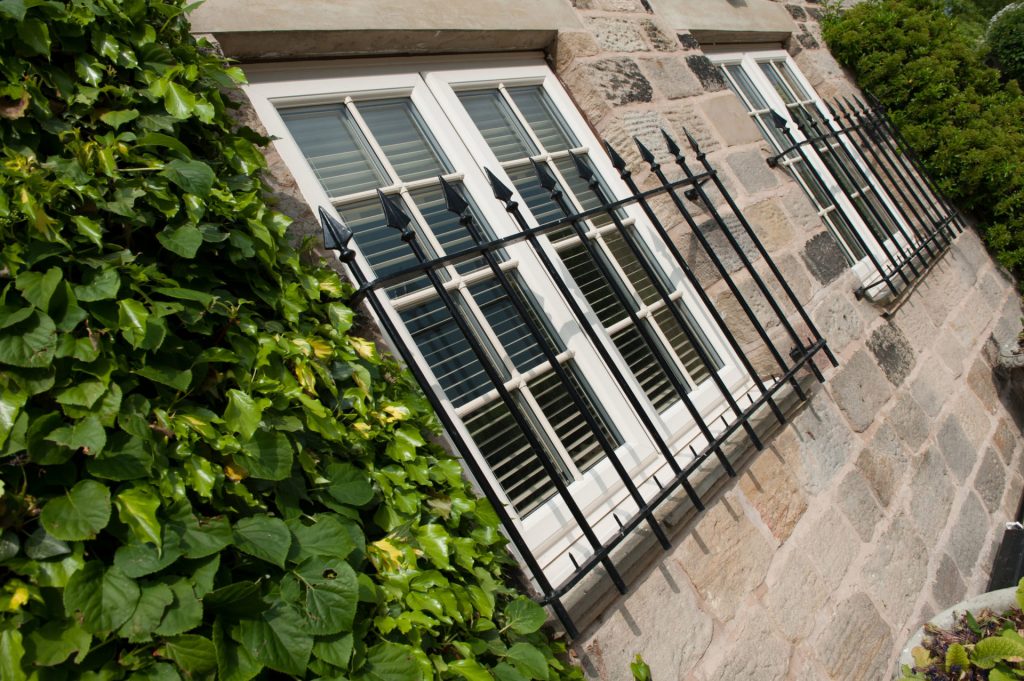 French windows with black grate period feature on external
